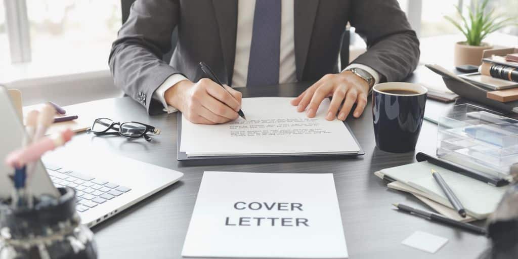 Person writing cover letter at tidy office desk