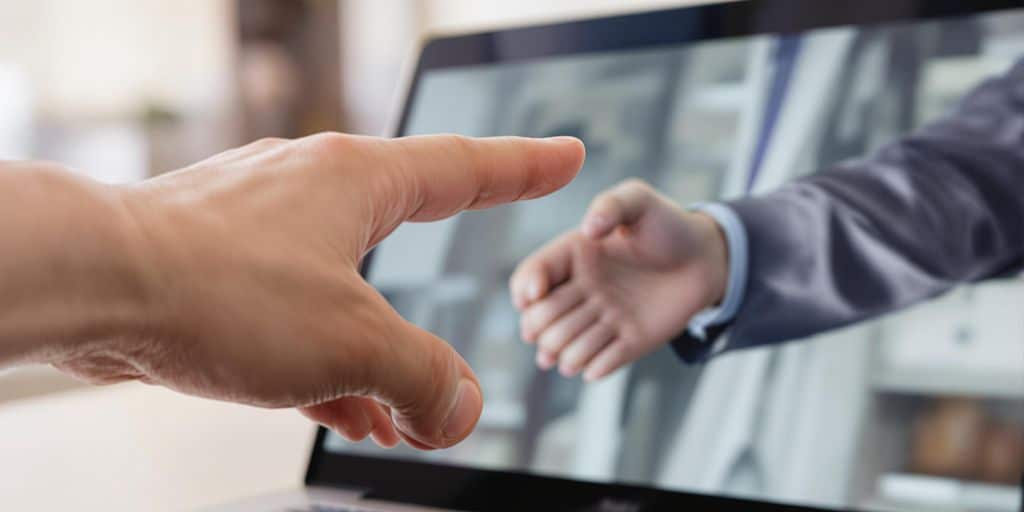 Professional connecting on a laptop screen.