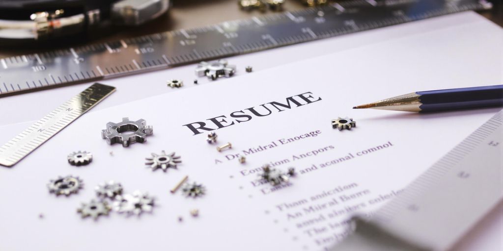 Resume, ruler, pencil, and gears.