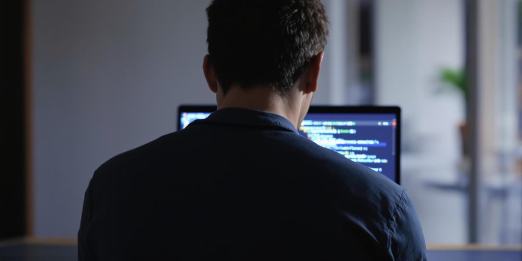 Programmer creating code on a laptop