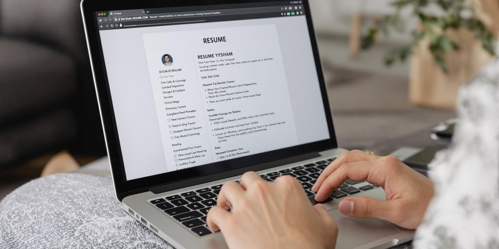 Laptop with a person creating a CV.