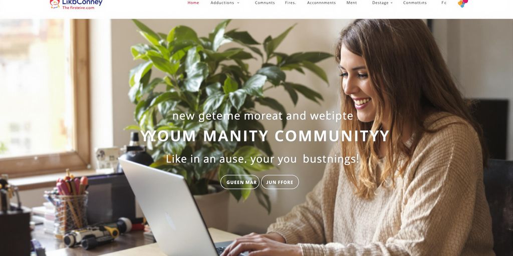 Person smiling, looking at a laptop