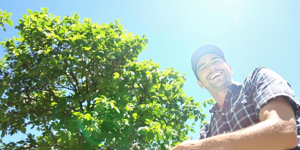Happy person working outdoors, no degree.