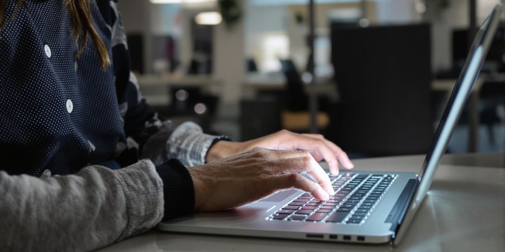 Person using laptop for AI job application.