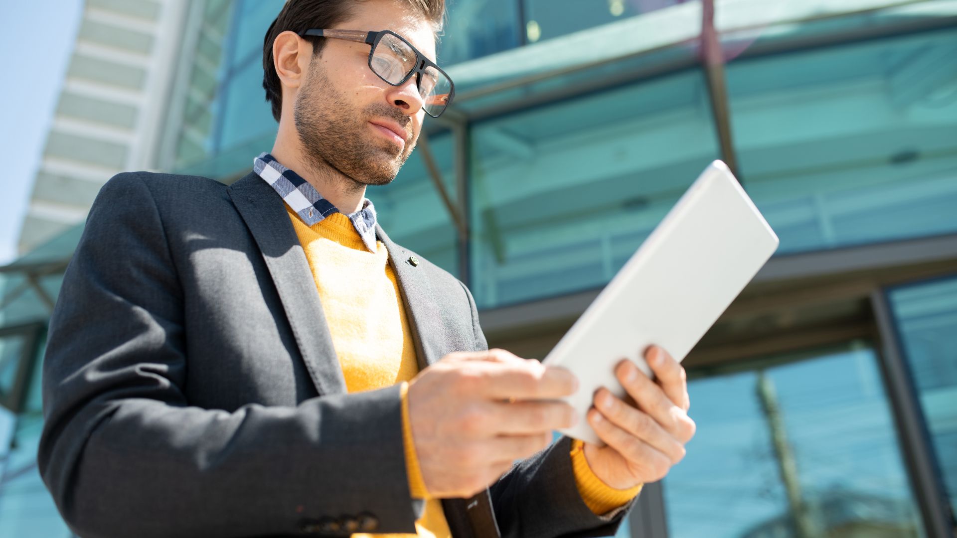 Looking at a paper outside a building